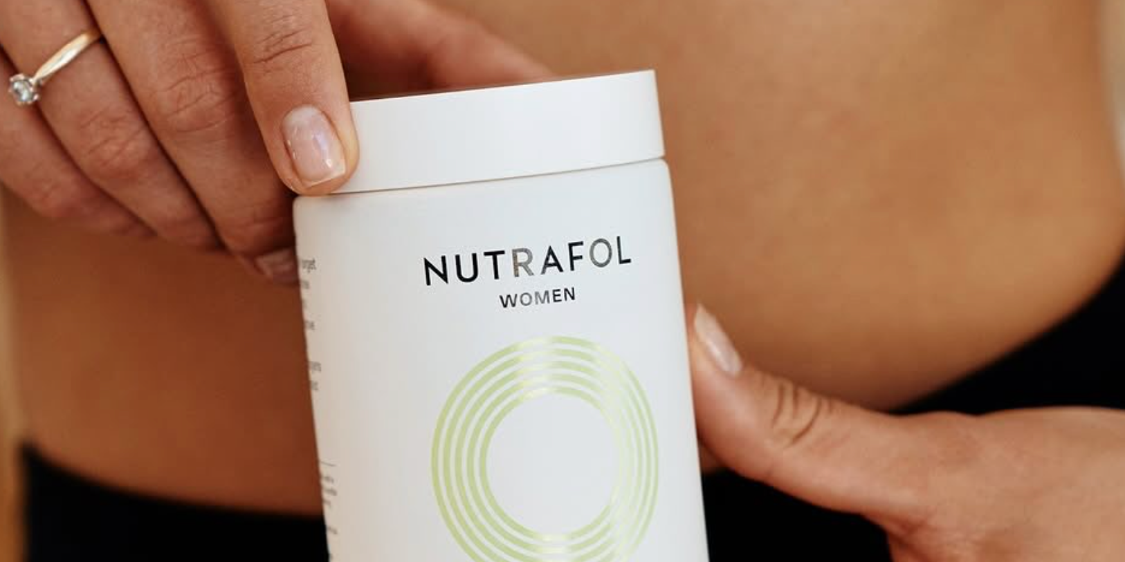 Woman Holding Bottle Labeled Nutrafol